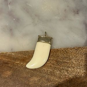 Gold and cream ‘tooth’ pendant.